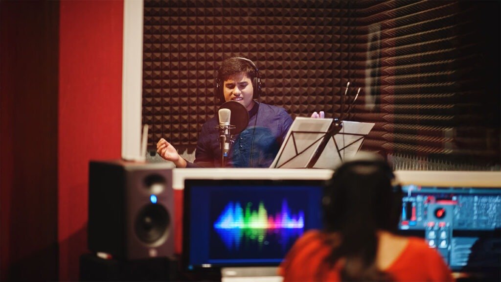 Singer recording vocals inside a professional song recording studio in Bhubaneswar